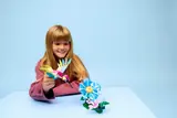 Child playing with LEGO hummingbird set.