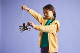 Child playing with LEGO spider.