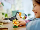 Child playing with LEGO Toucan.