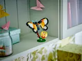 LEGO moth on a shelf.