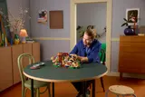 Man building Wonka LEGO.