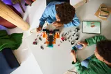 Kids building LEGO Minecraft Wither set.