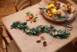 LEGO Holiday Garland with red berries on a craft table.