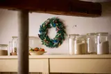 LEGO Holiday Wreath with blue berries in a kitchen setting.