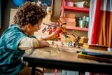 Kid playing with Ninjago set.
