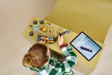 Child building with digital instructions.