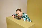 Child with completed LEGO set.