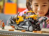 Child adjusting LEGO bulldozer ripper.
