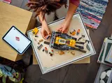 Overhead view of LEGO bulldozer build with digital instructions.