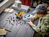 Child building LEGO with app.