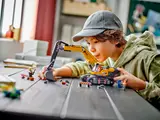 Child playing with LEGO Excavator.