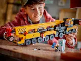 Boy holding detailed LEGO crane.