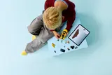 Child building LEGO taxi