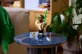 LEGO Yoda bust on blue table.