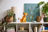 LEGO Young Simba on a shelf with decor.
