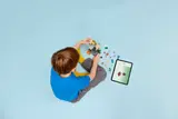 Child building LEGO Minecraft.
