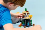 Kid adjusting Minecraft minifigure.