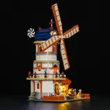 Side view of the lit windmill at night.