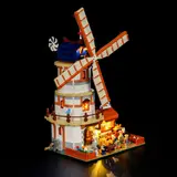 Rear-side view of the lit windmill and farm.