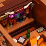Bar shelf with lit colored bottles.