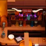 Lit colored bottles on bar shelf.