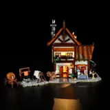 Wider view of illuminated tailor shop at night.