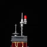 Close-up of lit red antenna at tower top.