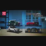 Four brick-built Mould King model cars in stacked clear display cases on a wooden surface, with blue ambient lighting.